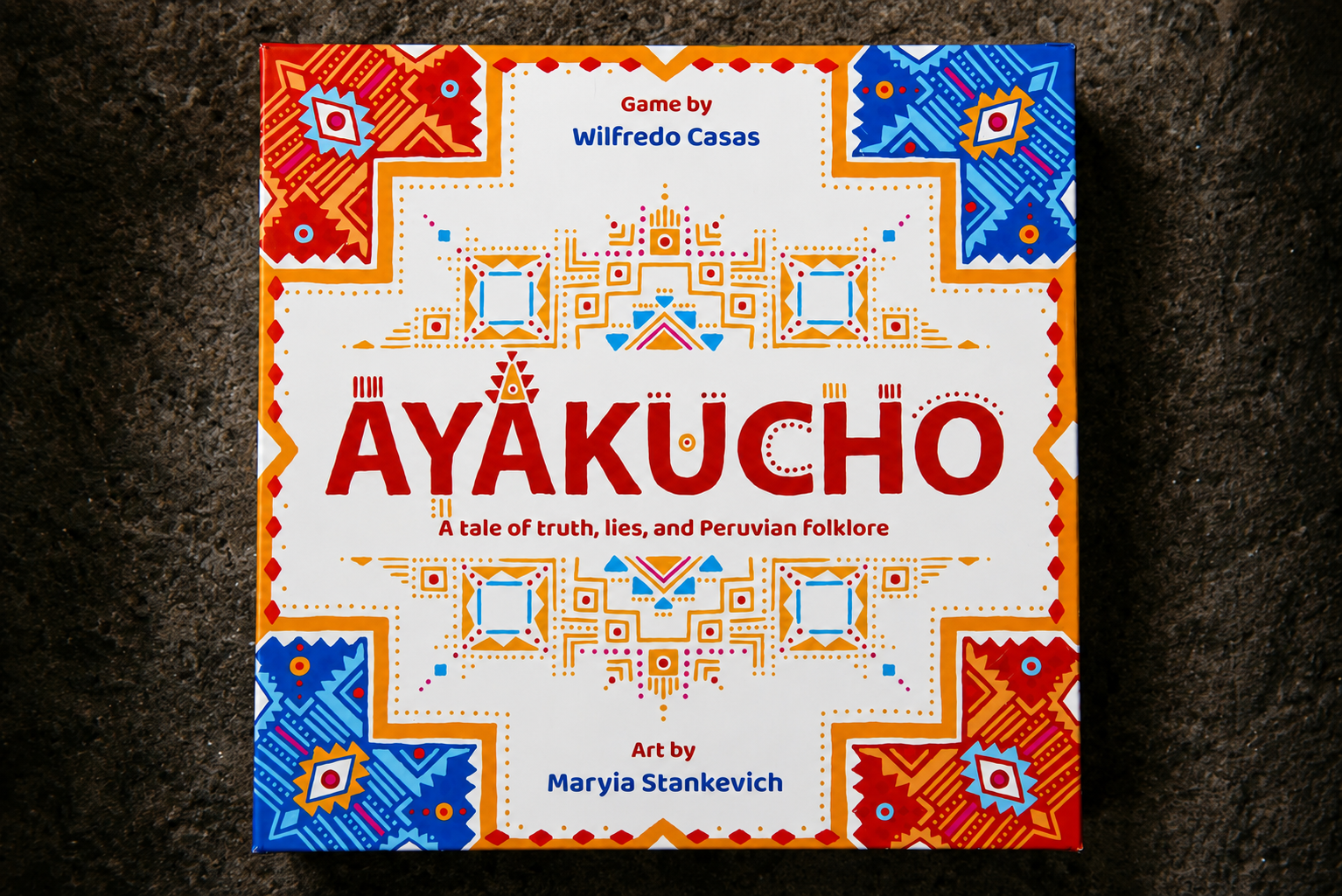 The Ayakucho game box and board laid out on a table, ready to play