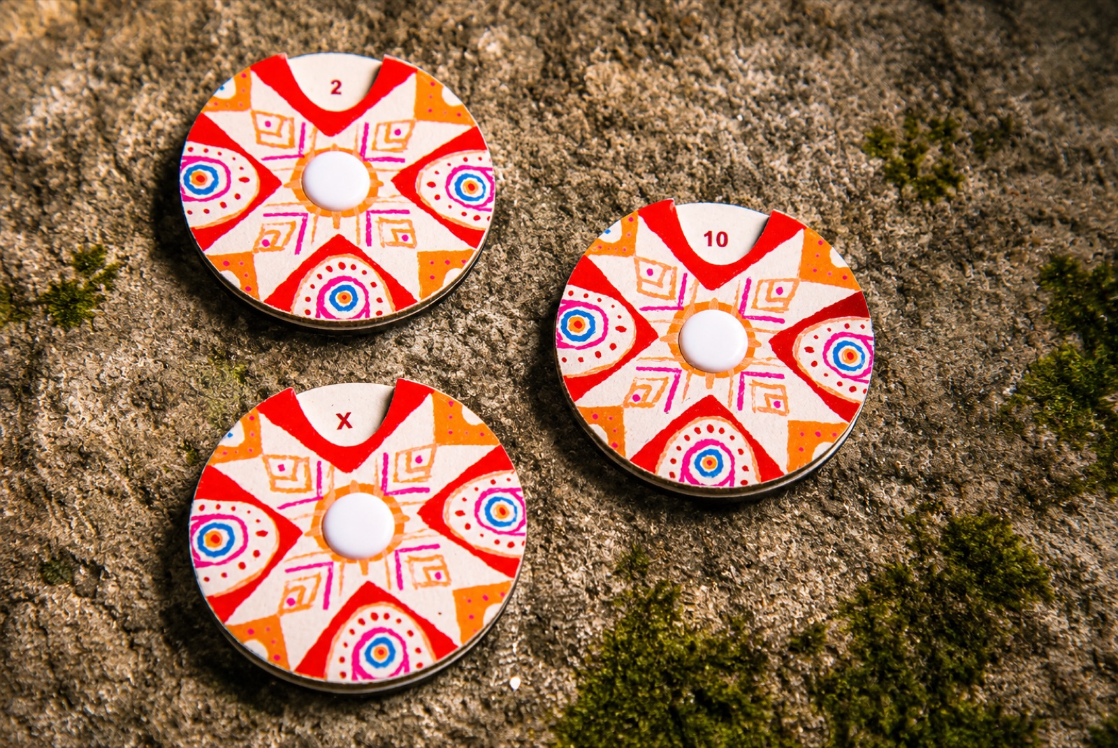 Close-up of hand-painted Andean artwork on a game card